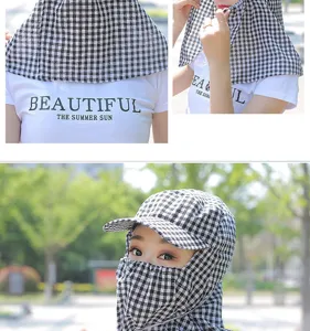 Detail view of the black and white checkered sun hat showing face and neck sun protection.