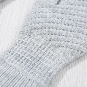 Grey knitted winter touch screen gloves close-up detail, warm and comfortable fabric design.