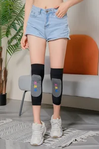 Detailed view of black knitted thermal knee warmers with graphene patch for winter outdoor use.