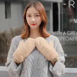 Close-up detail of winter warm furry mittens with lanyard, soft plush texture and cozy design.