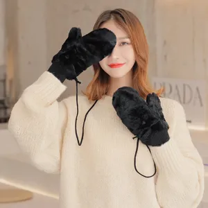 Detailed shot of winter warm black furry mittens with lanyard, soft texture, cozy cold weather gear.