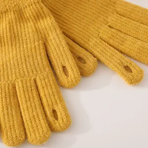 Yellow knitted winter gloves with touchscreen fingertip openings for warm daily wear and cold days.