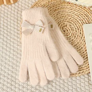 Cozy pink knit gloves for women featuring a cute bow and metal detail, warm winter handwear.