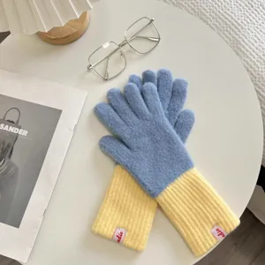Cozy blue and yellow color-blocked knitted gloves detail view, soft winter wool accessory.