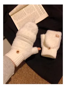 Close-up detail of white plush convertible fingerless gloves, soft winter warm knit wear for women.