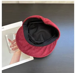 Classic red suede newsboy cap for women, stylish retro octagonal hat with soft interior.