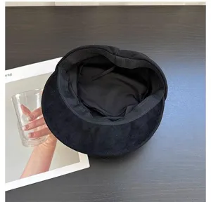 Black suede newsboy cap for women, retro octagonal hat with classic British style, soft fabric.