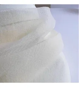 Close-up detail of white sheer organza mesh fabric, lightweight and breathable texture.
