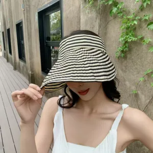 Black and white striped sun hat detail, wide brim design for outdoor summer UV protection.