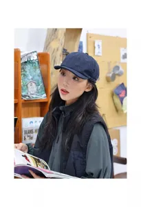 Detail shot of a stylish dark blue short brim baseball cap worn by an Asian model in bookstore.