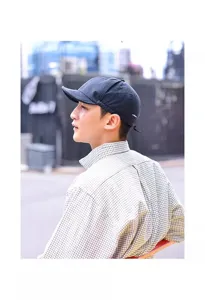 Detailed side view of the Japanese style short brim baseball cap worn for summer styling.