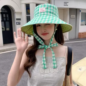 Chapeau bob à carreaux verts pour femme, large bord anti-UV pour la protection solaire.