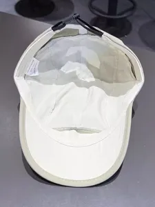 Detailed interior view, stitch craftsmanship and washing label of the summer baseball cap.
