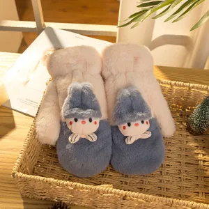 Cozy winter plush mittens detail shot, featuring cute cartoon doll decor and thick fleece lining.