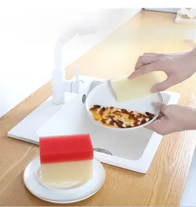 Detail view of kitchen cleaning sponge in use, showing powerful scrubbing and water absorption.