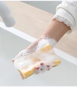 Kitchen wood pulp sponge dishwashing scouring pad detail showing absorbent cleaning performance.