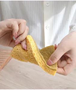 Sisal wood pulp sponge dual-sided dish washing cleaning pad for kitchen sink and pot use.