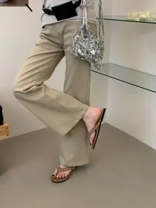 Gedetailleerd overzicht van platte teenslipper-sandalen met stijlvolle geniete bandjes.