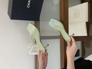 Light green high heel sandals featuring clear transparent strap design and elegant stiletto heels.