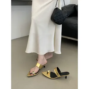 Eleganti mules da donna con punta affilata, tacco basso e fibbia in metallo dorato chic.