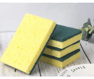 Close-up detail of dual-sided kitchen cleaning sponges, yellow sponge with green scouring pad.
