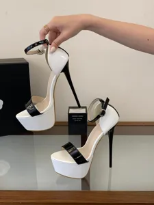 Black and white patent leather high heels with platform and ankle strap for pole dance.