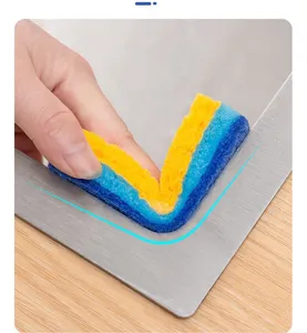 Close-up detail of cleaning sponge bending to fit corner, soft wood pulp sponge for kitchen.