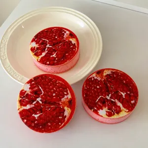 Round wood pulp dishwashing sponge with pomegranate print for kitchen cleaning use main view.