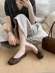 Comfortable brown split-toe flat ballet shoes for women with cute bow detail and soft sole.