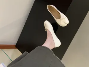 Beige split-toe ballet flats for women with cute bow detail, casual comfortable flat shoes.