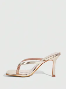 Metallic gold thong high heel sandal detail view, elegant square toe party shoe closeup.