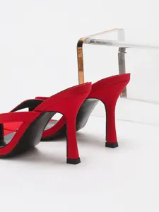 Red stiletto heel thong sandals detail shot, elegant party high heels footwear for women.
