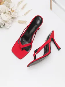 Red stiletto thong sandals featuring square toe design and sleek high heels for party wear.