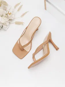 Close-up detail of stylish women's nude thong high heel sandals with elegant stiletto.
