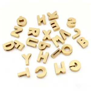 Close-up detail of 8mm bronze metal alphabet letter charms for DIY jewelry making crafts.