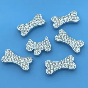 Detail view of crystal rhinestone dog bone slider charms, metal DIY accessories for pet collars.