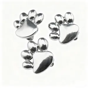 Closeup detail of 10mm metal silver paw print DIY charms for pet collars and bracelets.
