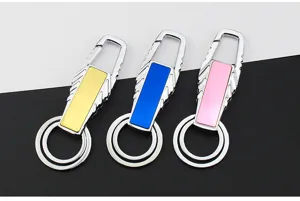 Close up shot of detailed metal keychains featuring colorful inserts and dual rings.