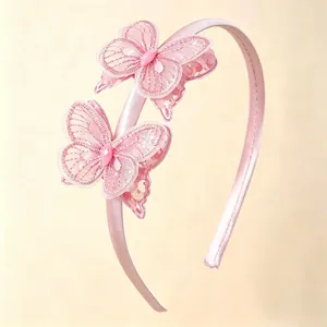Pink satin headband detail featuring double mesh lace butterfly decorations with sequins.