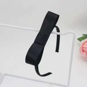 Black satin ribbon bow headband for girls, elegant hair accessory for children and daily wear.
