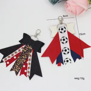 Cheerleader bow keychain bag charm with cute football and leopard print design details.
