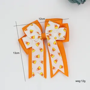 Nœud pour cheveux orange pour enfants avec imprimé bonbon, accessoire de coiffure stylé.