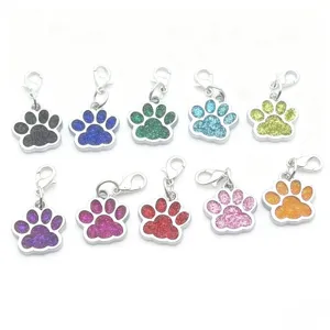 Colorful metal paw print charms with lobster clasps, cute pet pendants for keys and collars.
