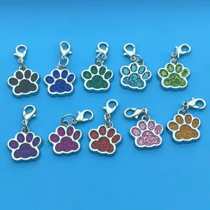 Set of 10 colorful glitter paw print metal keychains with lobster clasps, cute pet charms.