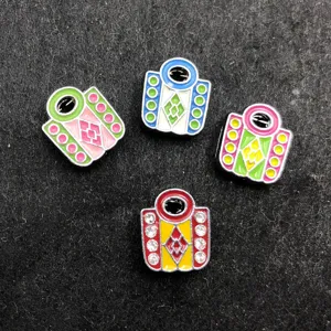 Detail view of four colorful 8mm enamel cartoon DIY charms with rhinestones on dark background.