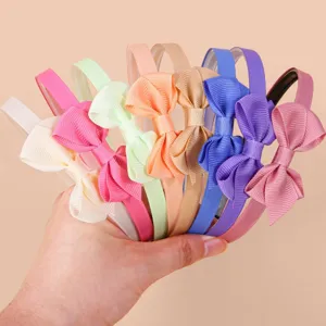 Detailed view of colorful ribbon bow hair hoops, sweet style hair accessories for daily wear.