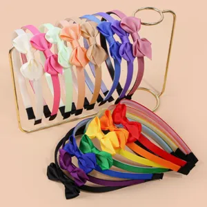 Colorful ribbed bow hair hoops detail view, sweet girls hair accessories close up display.