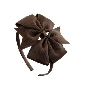 Brown grosgrain ribbon swallowtail bow headband detail shot showing clear texture and sweet design.