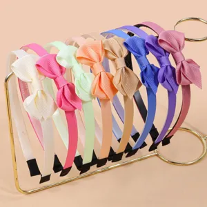 Close-up detail of colorful grosgrain ribbon hair hoops, cute bow headbands set for girls.