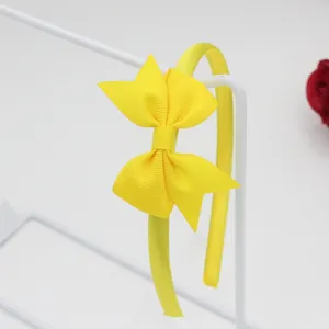 Serre-tête simple avec nœud ruban jaune pour filles, accessoire de cheveux uni élégant.